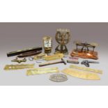 A set of brass scissor action letter scales, another set of postal scales, a clockwork desk top