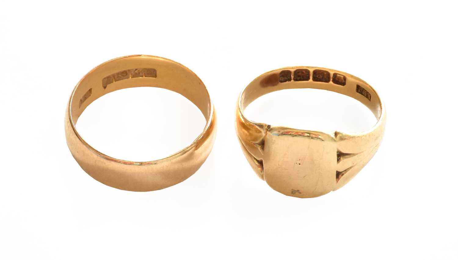 An 18 carat gold band ring, finger size N; and an 18 carat gold signet ring, finger size MGross