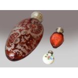 A Victorian etched ruby glass scent bottle, 16cm; together with a small porcelain scent bottle