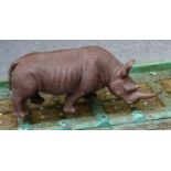 A carved wooden sculpture of a rhinoceros, approximately 60cm