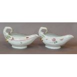 A pair of Worcester cos lettuce moulded sauceboats, circa 1758, painted in polychrome enamels with