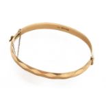 A 9 carat gold hinged bangle, inner measurements 6.2cm by 5.3cmGross weight 23.7 grams.