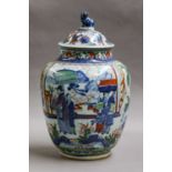 A Chinese wucai jar and cover, transitional style but probably 19th century, with a moulded dog of