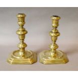 Two pairs of 19th-century brass candle sticks, the tallest 26cm, shortest 22cm high Thank you for