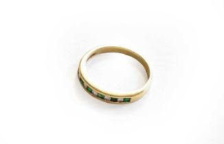 A emerald and diamond half hoop ring, stamped '14Kt', finger size LGross weight 2.1 grams.