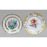 A Berlin porcerlain plate with yellow borders and floral sprays togther with a further Berlin plate,