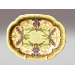 A Sevres Art Nouveau quatrefoil dish, tube lined with stylized lilies on a textured gilt ground,