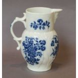 A Caughley leaf-moulded mask jug, circa 1775, printed in underglaze blue with the Three Flowers