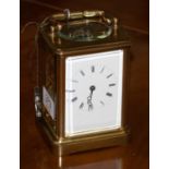 A brass striking carriage clock, circa 1890, carrying handle, enamel dial with Roman numerals,