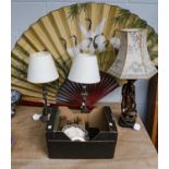 An oversized Oriental silk fan painted with cranes, a Chinese style figural plaster table lamp, a