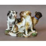 A Meissen group after an original by J.J Kandler, 19th century, bolgnese hounds and a pug, raised on