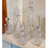 A group of four glass decanters by William Yeoward and a similar jug, three further decanters each