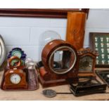 A German striking mantel clock, glass dome on a wooden base, 44cm high, two smaller glass domes, two