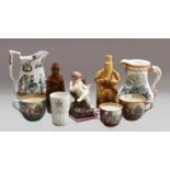 A group of 19th century ceramics, including a Wood & Cauldwell creamware figure of a seated puto,
