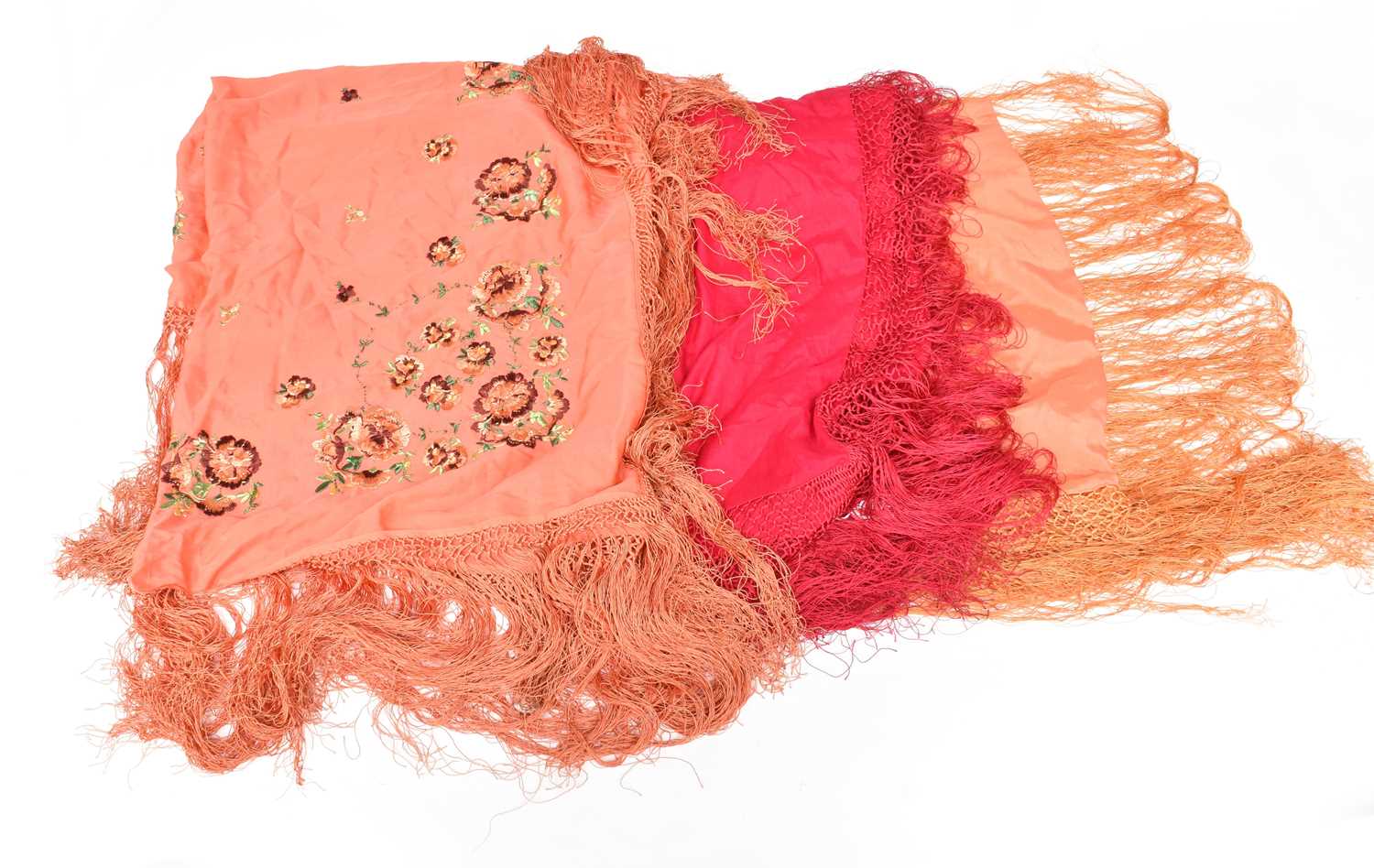 Early 20th Century Silk Evening Shawls, comprising a bright pink example with fringing, 110cm