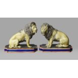 A pair of majolica models of seated lions, late 19th century, naturalistically modelled and each