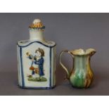 A prattware tea caddy and cover, circa 1820, moulded in relief to the front and rear with a seated