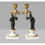 A pair of French parcel-gilt bronze figural candlesticks, 19th century, each formed as an Oriental