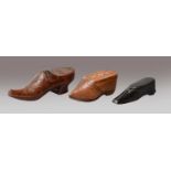 A Victorian boot form carved wooden snuff box and two Dutch examples in the form of clogs