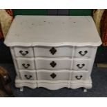 A cream painted three-height chest of drawers,...