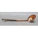 An 18th century food strainer spoon with copper bowl and turned handle