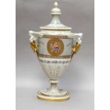 A porcelain urn form vase and cover with caryatid form handles and painted with floral sprays,