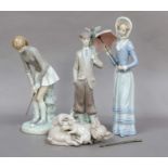 Three Lladro figures, together with a Lladro group of pigs