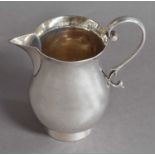 A George V Silver Cream Jug, by Stokes and Ireland, Chester, 1934, baluster and on collet foot, with