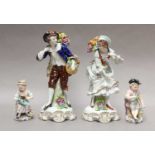 A pair of Sitzendorf figures 'Fruit Pickers' and two further continental figures, the tallest