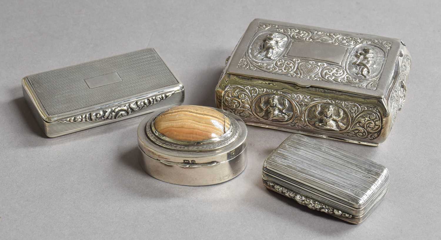 A collection of four silver boxes, two oblong, one reeded the other engine-turned, one oval and with