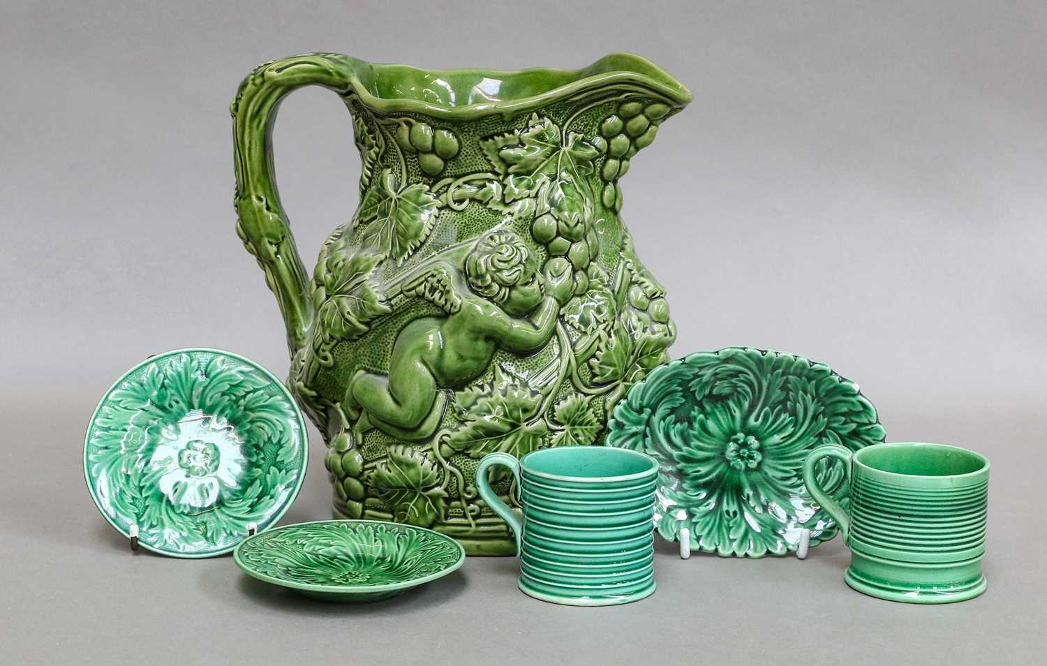 A Minton's Majolica jug, shape number 589, decorated with putto and vines, together with a group