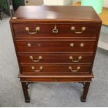 A reproduction Chippendale style mahogany secretaire chest on stand, raised on square supports