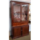 A mahogany bookcase, part 19th century, the dentil cornice above glazed doors, with deep drawer