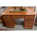 A 20th century kneehole desk, 122cm by 56cm by 77cm, two open hanging shelves, an oak gateleg table,