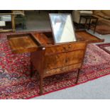 A George III mahogany washstand, the two-section foldout top opening to reveal an easel back