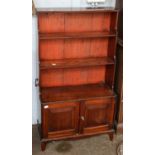 A mahogany waterfall bookcase, 66cm by 30cm by 117cm