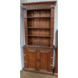 A pair of carved oak open bookcase cabinets, 98cm by 31cm by 214cm