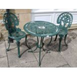 A pair of green painted metal garden chairs and a matching circular table, together with a pair of