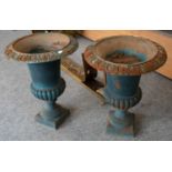 A pair of blue painted cast iron campana form garden urns, 60cm high