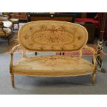 An early 20th-century French style painted and parcel-gilt hardwood parlour settee with original