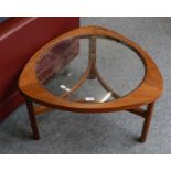A 1960's teak and glass coffee table, the three legs joined by shaped stretchers, 74cm by 76cm by