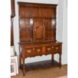 An early 20th century oak dresser and rack, with two frieze drawers, plain turned supports and a pot