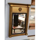 A small Regency gilt framed inverted breakfront wall mirror, with bevelled plate and ebonised