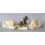 A pair of small carved alabaster recumbent lions, 21cm, together with a bronze figure of Cupid and a