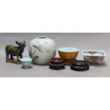 A Chinese glazed stoneware model of a cow, three Chinese porcelain bowls and a ginger jar (lacking