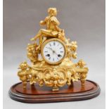 A Victorian gilt metal striking mantel clock beneath a glass dome, clock 29cm high