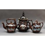 A collection of Measham Bargewares comprising four teapots, one on a stand, and a jug, dated from