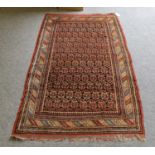 North West Persian rug, the field of boteh enclosed by barber pole borders, 180cm by 112cmThere