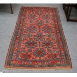 Hamadan rug, the coral pink field of stylizerd flowerheads enclosed by narrow borders, 198cm by