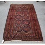 Baluch rug, the field of "Salor" guls enclosed by multiple borders, 188cm by 104cm